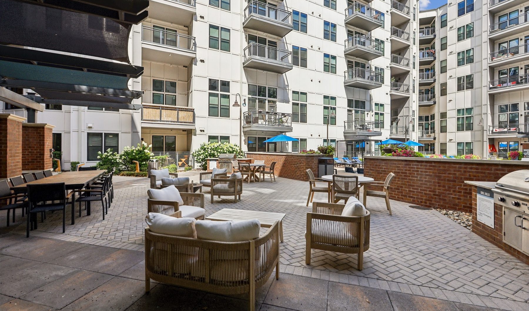 a courtyard with grills, tables and chairs